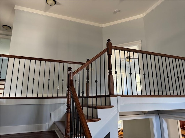 staircase featuring baseboards and ornamental molding