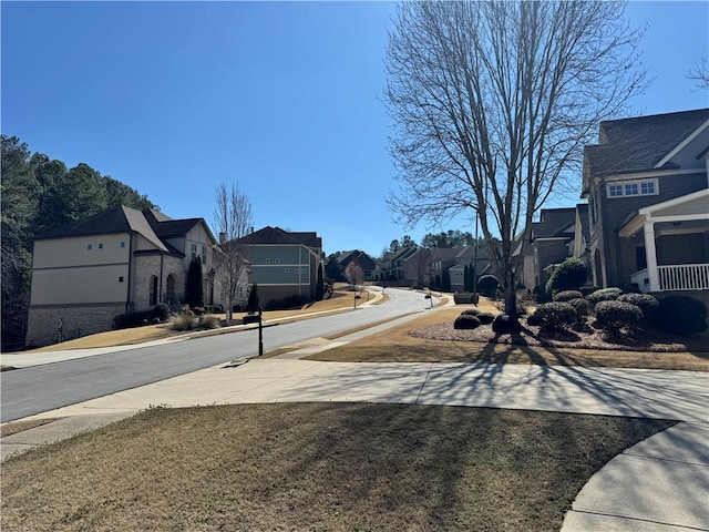 view of street featuring a residential view, curbs, and sidewalks