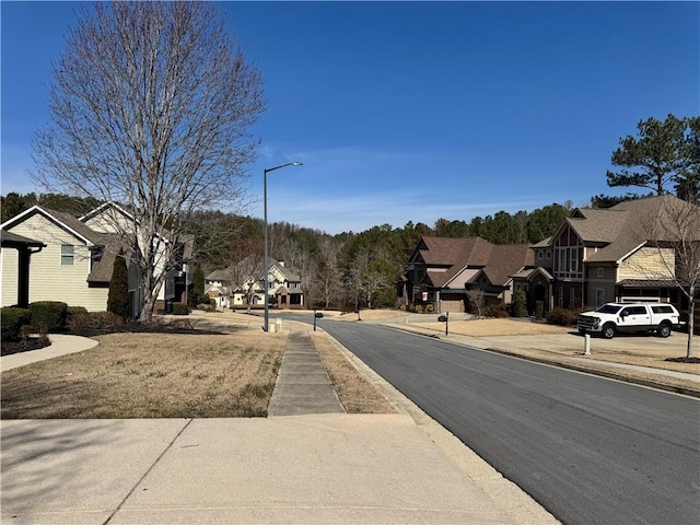 view of street with street lighting, a residential view, and sidewalks