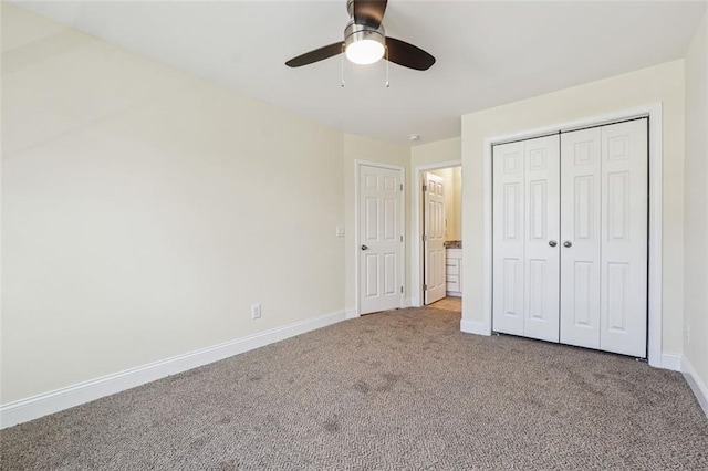 unfurnished bedroom featuring ceiling fan, a closet, and carpet floors