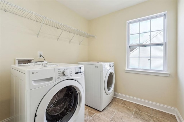 clothes washing area featuring independent washer and dryer and a healthy amount of sunlight