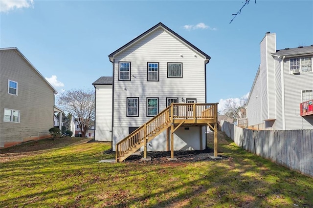 back of house featuring a deck and a yard