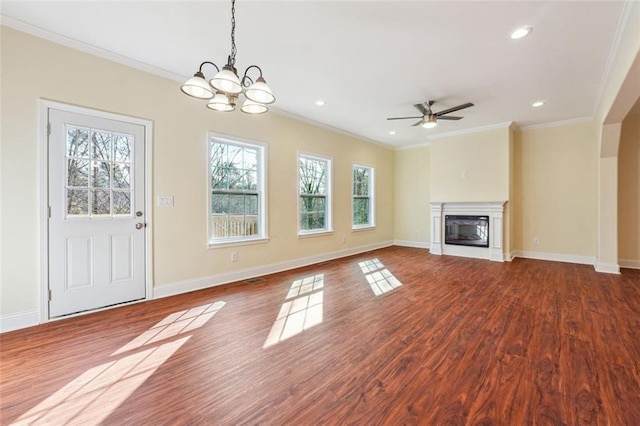 unfurnished living room featuring ornamental molding, ceiling fan with notable chandelier, and hardwood / wood-style floors