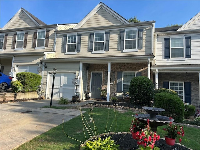 127 Spring Way Sq, Canton, GA 30114 - townhome / multi-family property featuring an attached garage, concrete driveway, and a front yard