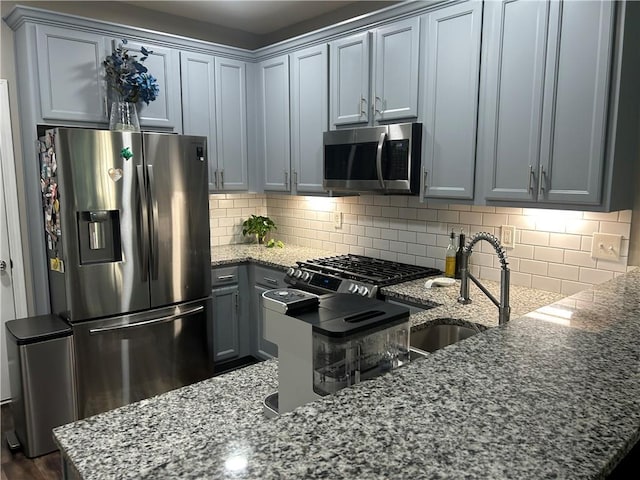 127 Spring Way Sq, Canton, GA 30114 - kitchen with appliances with stainless steel finishes, dark stone counters, and tasteful backsplash