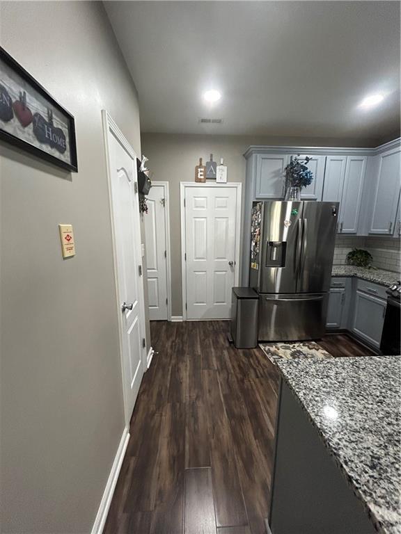 127 Spring Way Sq, Canton, GA 30114 - kitchen with stainless steel fridge with ice dispenser, dark wood-style floors, light stone countertops, and tasteful backsplash