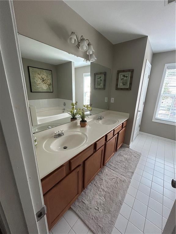 127 Spring Way Sq, Canton, GA 30114 - bathroom with tile patterned floors, double vanity, and a garden tub