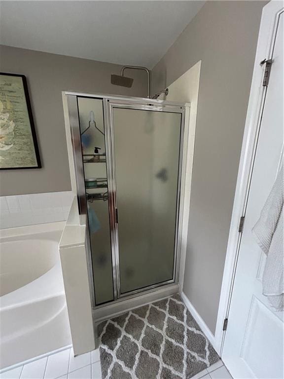 127 Spring Way Sq, Canton, GA 30114 - bathroom featuring a shower stall, tile patterned flooring, and a bath