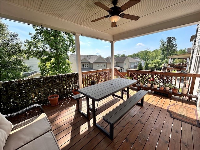 wooden deck with ceiling fan and outdoor dining area