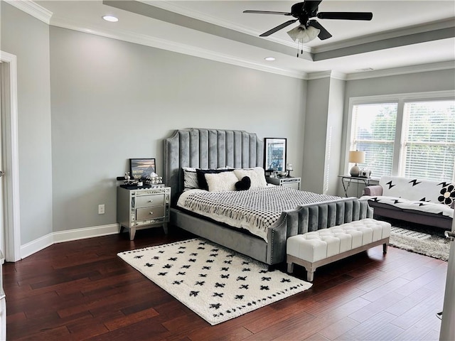 bedroom featuring ceiling fan, hardwood / wood-style floors, recessed lighting, baseboards, and a tray ceiling