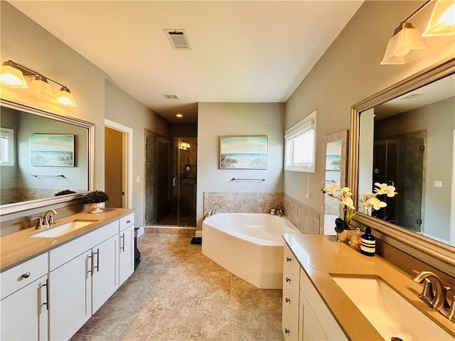 bathroom featuring a sink, two vanities, a shower stall, and visible vents
