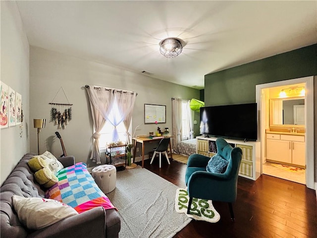 living room with dark wood-style floors and visible vents