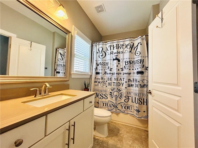 bathroom with visible vents, shower / tub combo with curtain, vanity, toilet, and stone finish flooring