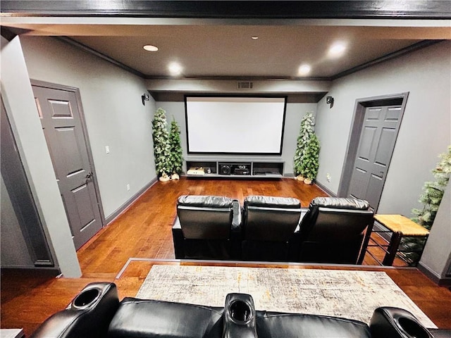 cinema featuring baseboards, ornamental molding, wood finished floors, and visible vents