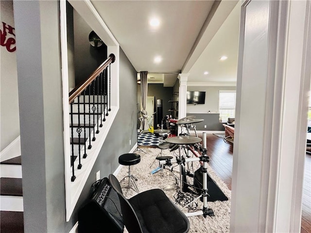 cinema with baseboards, ornamental molding, and wood-type flooring
