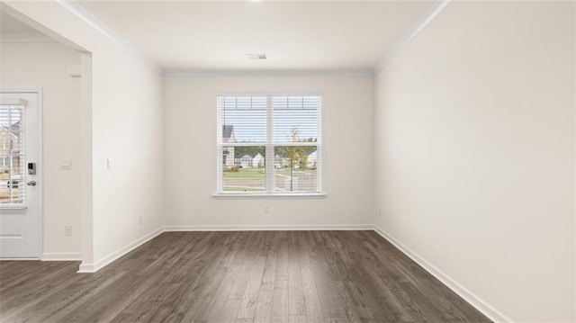 989 Blue Juniper Cir, Loganville, GA 30052 - spare room with baseboards, visible vents, crown molding, and dark wood-style flooring