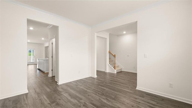 989 Blue Juniper Cir, Loganville, GA 30052 - spare room with dark wood finished floors, baseboards, stairway, and ornamental molding