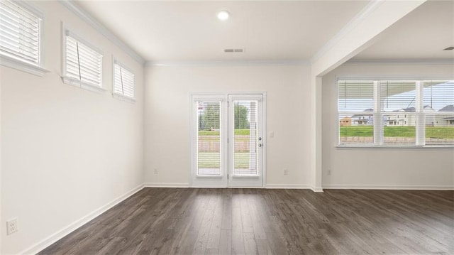 989 Blue Juniper Cir, Loganville, GA 30052 - unfurnished room featuring ornamental molding, dark wood-style floors, baseboards, and visible vents
