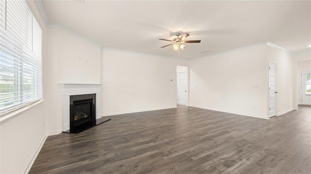 989 Blue Juniper Cir, Loganville, GA 30052 - unfurnished living room with dark wood finished floors, ceiling fan, ornamental molding, and a fireplace with raised hearth