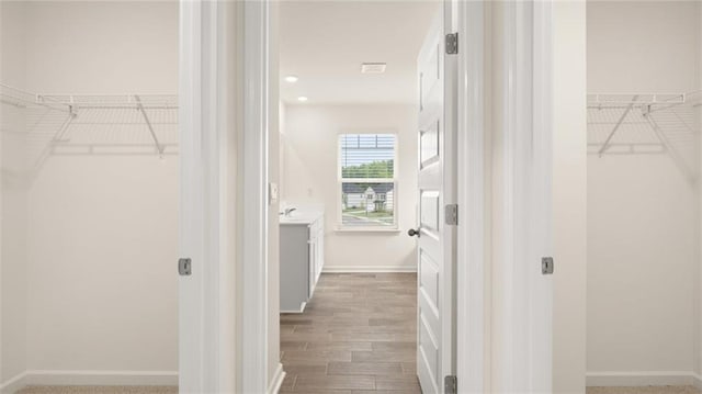 989 Blue Juniper Cir, Loganville, GA 30052 - walk in closet with wood finished floors
