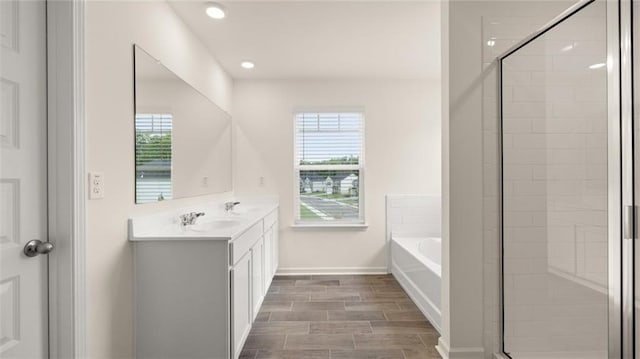 989 Blue Juniper Cir, Loganville, GA 30052 - full bath with a sink, a shower stall, double vanity, a bath, and recessed lighting