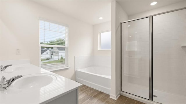 989 Blue Juniper Cir, Loganville, GA 30052 - full bath featuring a sink, a bath, a stall shower, and a wealth of natural light