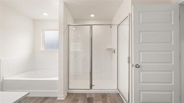 989 Blue Juniper Cir, Loganville, GA 30052 - full bathroom featuring a stall shower, a garden tub, and wood tiled floor