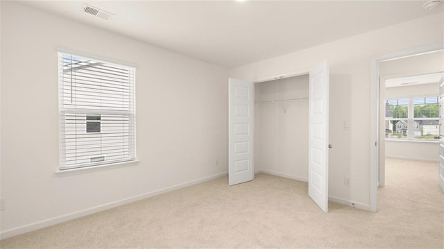 989 Blue Juniper Cir, Loganville, GA 30052 - unfurnished bedroom featuring light colored carpet, visible vents, and baseboards