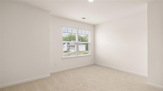 989 Blue Juniper Cir, Loganville, GA 30052 - spare room with baseboards, visible vents, and light colored carpet