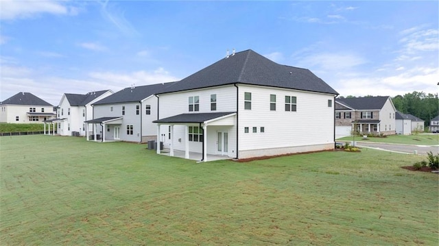 989 Blue Juniper Cir, Loganville, GA 30052 - rear view of house with a residential view, a patio area, and a lawn