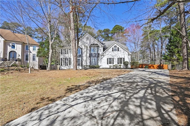 view of front of home with stone siding and fence