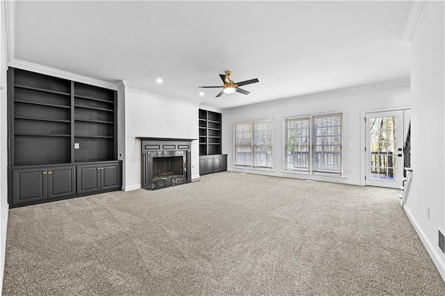 unfurnished living room featuring baseboards, carpet floors, ornamental molding, and a high end fireplace