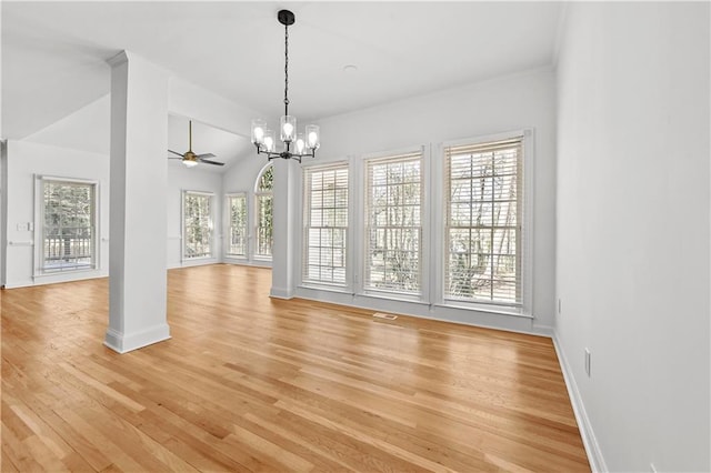 unfurnished dining area with light wood-type flooring, baseboards, lofted ceiling, and ceiling fan with notable chandelier