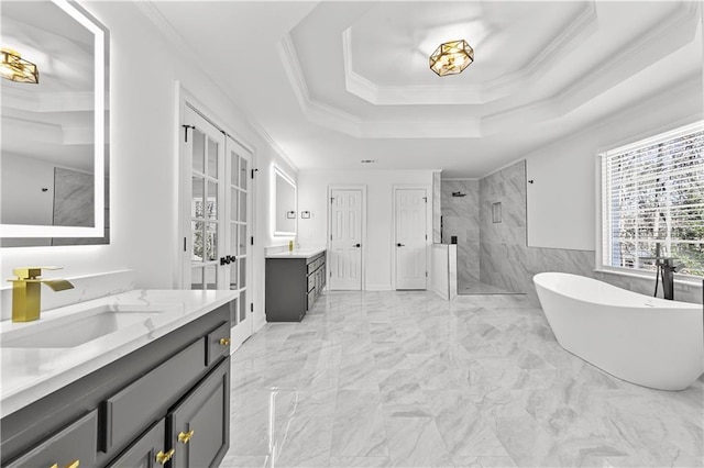 full bath with a tray ceiling, ornamental molding, a sink, a shower stall, and marble finish floor