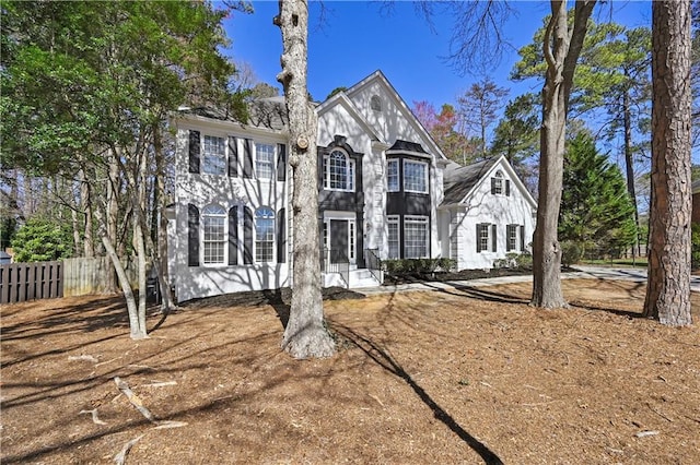 view of front of home featuring fence