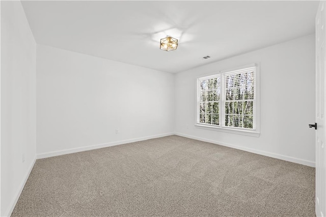 unfurnished room with carpet flooring and baseboards