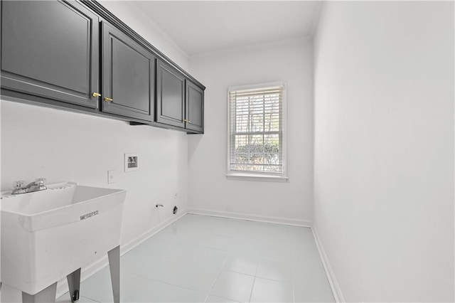 laundry area featuring light tile patterned floors, baseboards, cabinet space, a sink, and washer hookup