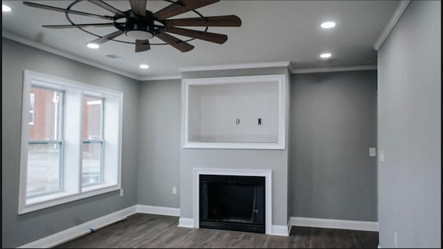 unfurnished living room featuring dark wood-type flooring, a wealth of natural light, and crown molding