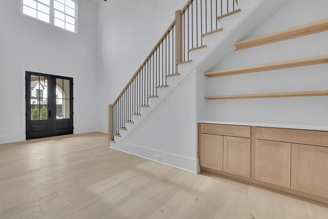 315 Hillcrest View Dr, Suwanee, GA 30024 - foyer with a towering ceiling, french doors, stairs, light wood-type flooring, and baseboards