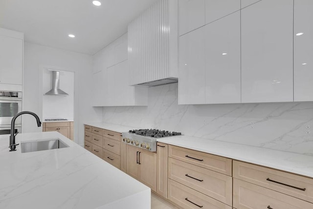 315 Hillcrest View Dr, Suwanee, GA 30024 - kitchen featuring stainless steel appliances, a sink, wall chimney range hood, light stone counters, and tasteful backsplash