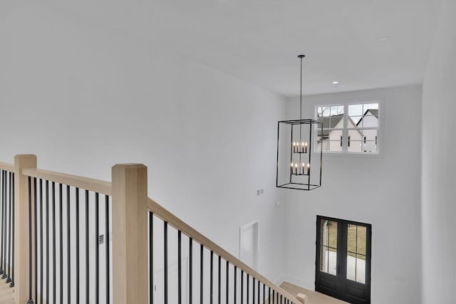 315 Hillcrest View Dr, Suwanee, GA 30024 - stairway featuring a chandelier, baseboards, and french doors