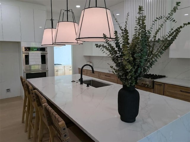 315 Hillcrest View Dr, Suwanee, GA 30024 - kitchen featuring a sink, stainless steel appliances, and white cabinetry