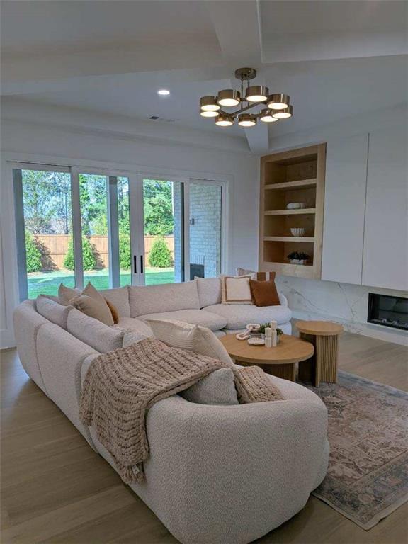 315 Hillcrest View Dr, Suwanee, GA 30024 - living room featuring a chandelier, healthy amount of natural light, recessed lighting, and light wood-type flooring