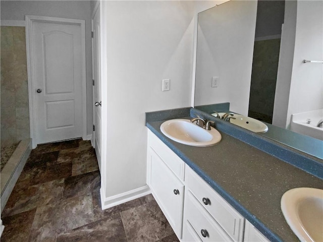 carpeted spare room featuring a raised ceiling, plenty of natural light, ceiling fan, and baseboards