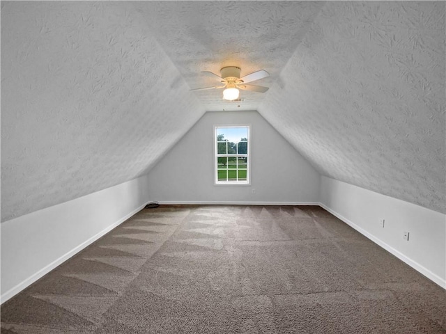 bonus room with carpet floors, lofted ceiling, ceiling fan, and baseboards