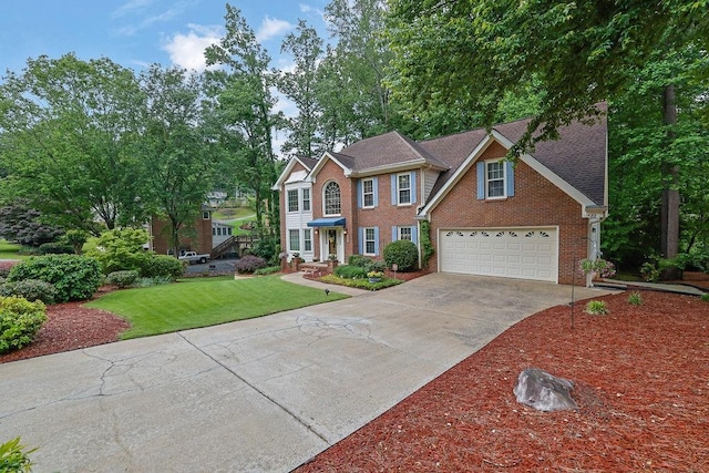 colonial inspired home featuring brick siding, driveway, a front yard, and an attached garage