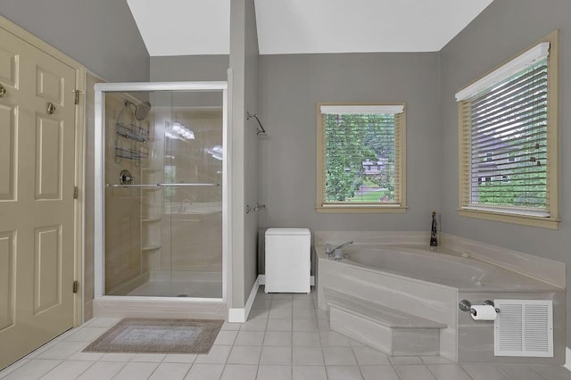 bathroom featuring tile patterned floors, a shower stall, and a garden tub