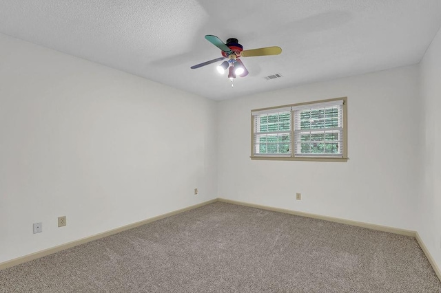 carpeted empty room featuring a ceiling fan and baseboards