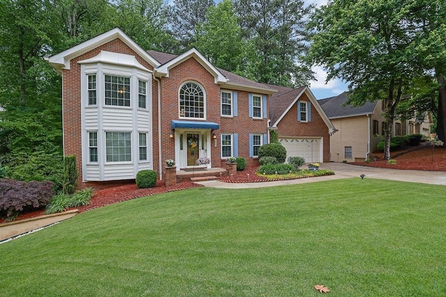view of front of property with brick siding, concrete driveway, and a front lawn