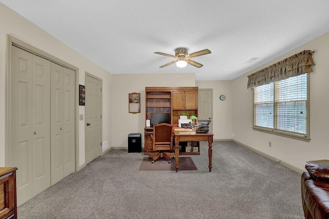 home office featuring a ceiling fan, carpet floors, and baseboards